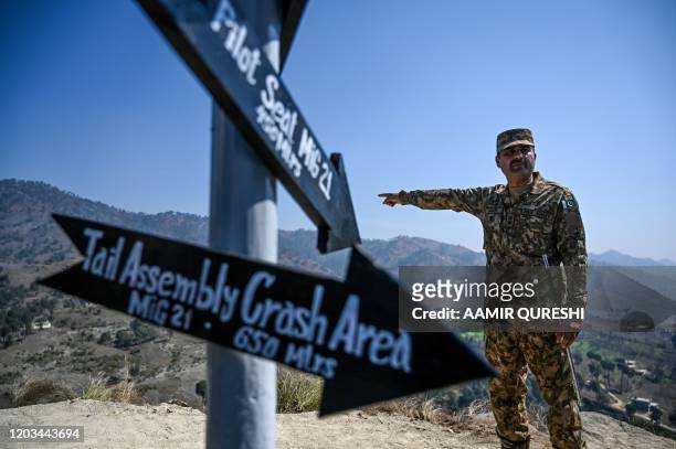 Pakistani army officer points out the site at Horran village, where an Indian Mig-21 fighter aircraft flown by pilot Wing Commander Abhinandan...