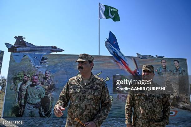 Pakistan's army Major General Shahid gives briefing to an international media team at Horran village near the site where an Indian Mig-21 fighter...