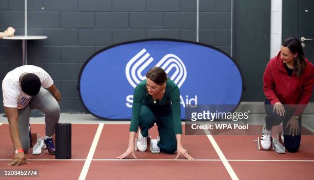 Catherine, Duchess of Cambridge prepares to race against para-athlete sprinter Emmanuel Oyinbo-Coker and heptathlete Jessica Ennis-Hill during a...