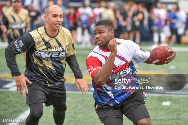 Carlos Arroyo and Tarik Cohen participate in the 20th Annual Super Bowl Celebrity Sweat Flag Football Challenge at Riccardo Silva Stadium on February...