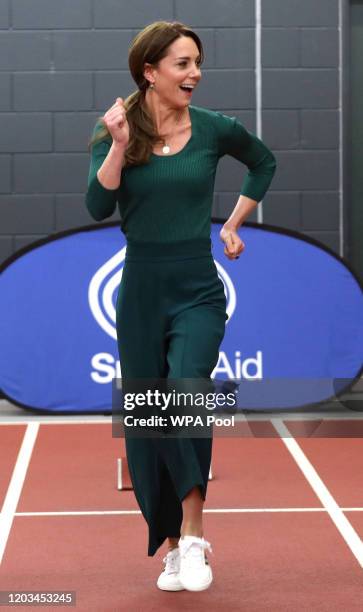 Catherine, Duchess of Cambridge smiles during a short race against para-athlete sprinter Emmanuel Oyinbo-Coker and heptathlete Jessica Ennis-Hill...