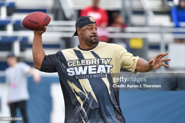 Former NFL Player Donovan McNabb looks to throw a pass during the 20th Annual Super Bowl Celebrity Sweat Flag Football Challenge at Riccardo Silva...