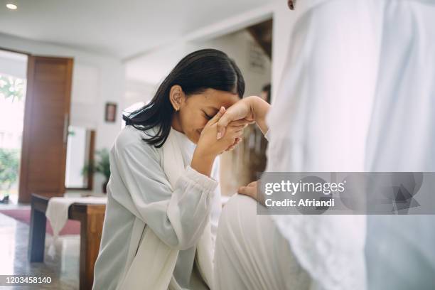 indonesian family celebrating eid al-fitr and asking for forgiveness - ramadan indonesia stock pictures, royalty-free photos & images