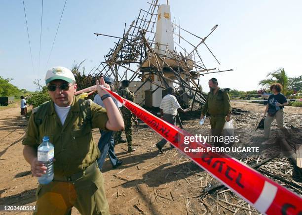 Israeli army investigators leave the scene where a bomb blast ocurred the day before in the Mombasa Paradise Hotel 29 November 2002. The death toll...