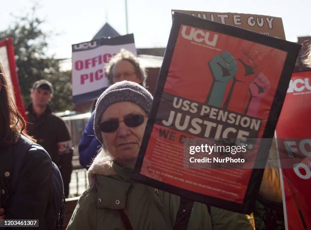 An elderly holds placards as takes part in a rally outside the Weston Bank Library at the University of Sheffield , in Sheffield , England , on 26...