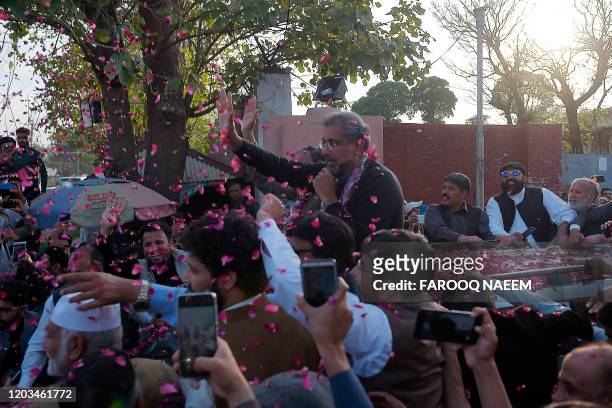 Pakistan's former prime minister Shahid Khaqan Abbasi waves to supporters outside the Adyala prison after being granted bail after months in...