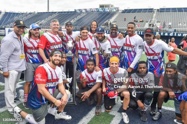 Former NFL Player Doug Flutie poses with his celebrity teammates after winning the 20th Annual Super Bowl Celebrity Sweat Flag Football Challenge at...