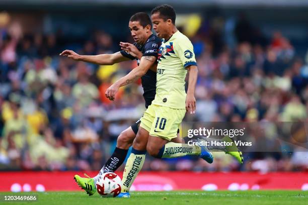 Giovani Dos Santos of America struggles for the ball against Victor Velazquez of FC Juarez during the 4th round match between America and FC Juarez...