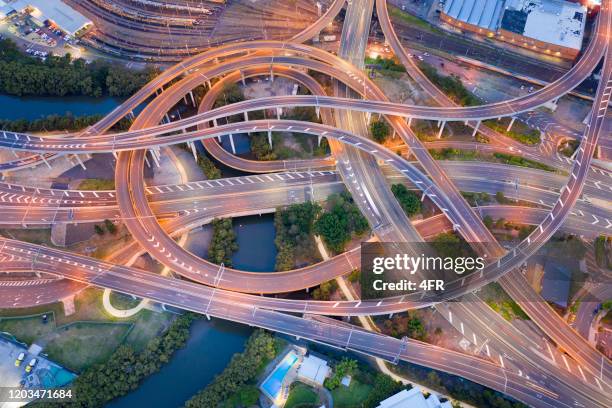 highway junction intersection and railroad tracks, brisbane, australia - crisscross stock pictures, royalty-free photos & images