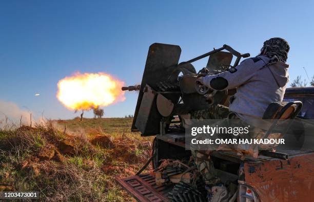 Turkey-backed Syrian fighter fires a truck-mounted gun toward the town of Saraqeb from the outskits of the villages of Afis and Salihiyah situated...