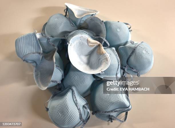 In this illustration dated February 26 protective N-95 face masks lie on a table at an office in Washington, DC. - A senior US health official warned...