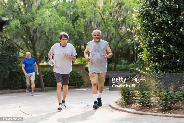 multi-ethnic senior men running in the park - 3 old men jogging stock pictures, royalty-free photos & images