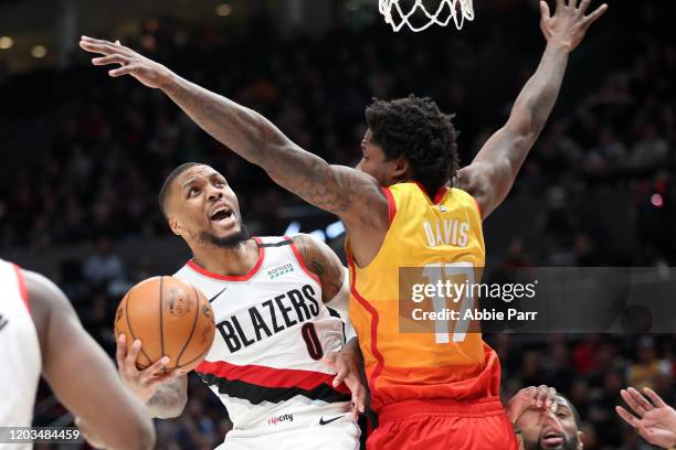 Damian Lillard of the Portland Trail Blazers takes a shot against Ed Davis of the Utah Jazz in the fourth quarter during their game at Moda Center on...