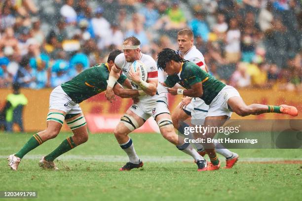 Ben Pinkelman of the USA is tackled during the 2020 Sydney Sevens Semi Final match between South Africa and USA at Bankwest Stadium on February 02,...