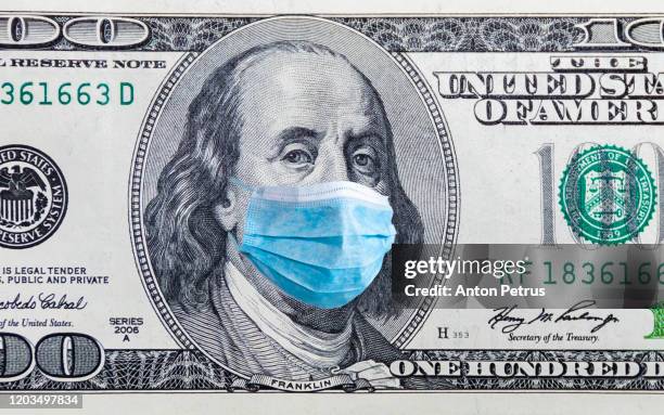 US quarantine, 100 dollar banknote with medical mask. The concept of epidemic and protection against coronavrius.