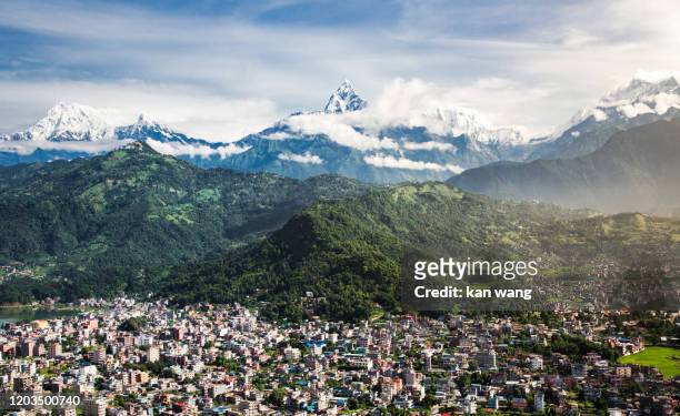 high angle view of houses and mountains against clear blue sky - stock photo - kathmandu tal stock-fotos und bilder