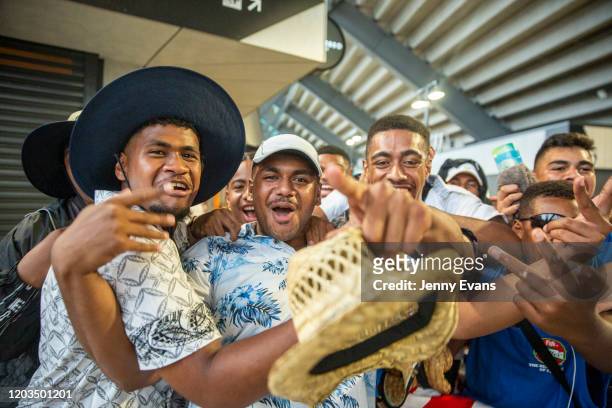 Fijian fans cheer as they pose for a photo in the concourse as rain falls during the 2020 Sydney Sevens match between Fiji and England at Bankwest...