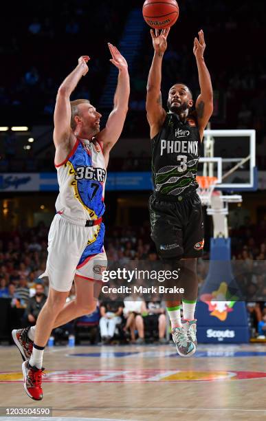 John Roberson of the Phoenix shoots for three over Brendan Teys of the 36ers during the round 18 NBL between Adelaide 36ers and the South East...