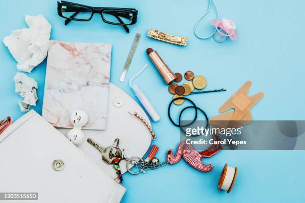 contents of woman mother bag - multi colored purse stockfoto's en -beelden