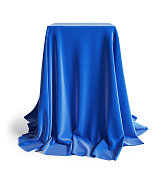 Empty podium covered with blue silk cloth. Isolated on a white background with clipping path.