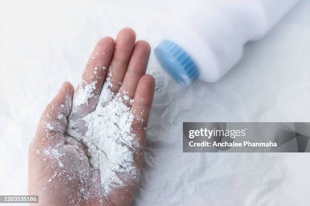 baby powder on mother's hand, dust dangerous for health concept. - magnesium stock-fotos und bilder