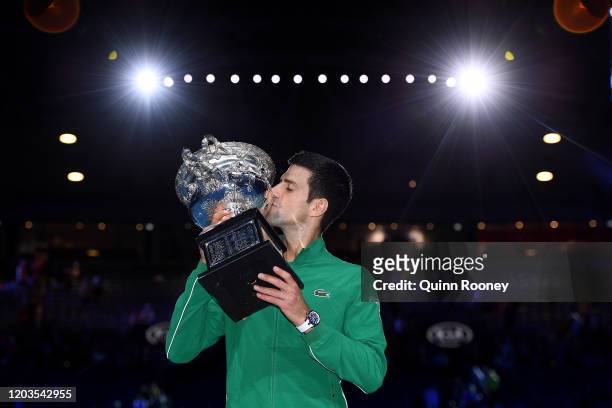Novak Djokovic of Serbia kisses the Norman Brookes Challenge Cup after winning the Men's Singles Final against Dominic Thiem of Austria on day...