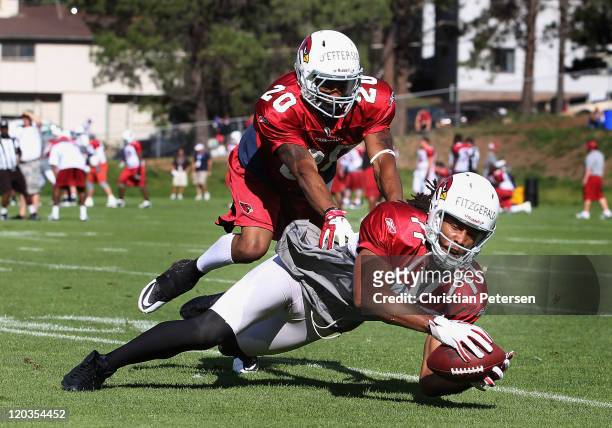 Wide receiver Larry Fitzgerald of the Arizona Cardinals catches a reception past cornerback A.J. Jefferson during the team training camp at Northern...