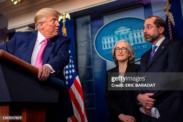 President Donald Trump turns to address US Secretary of Health Alex Azar as he speaks during a news conference on the COVID-19 outbreak at the White...