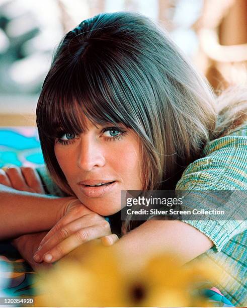 Julie Christie, British actress, wearing a short-sleeved turquoise knitted top, circa 1965.