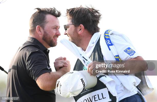 Graeme McDowell of Northern Ireland celebrates with his caddie during Day 4 of the Saudi International at Royal Greens Golf and Country Club on...