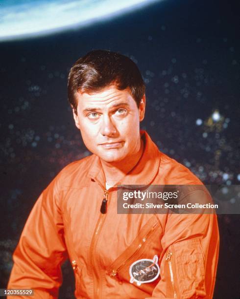 Larry Hagman, US actor, wearing orange overalls with the NASA badge, issued as publicity for the US television series, 'I Dream of Jeannie', USA,...