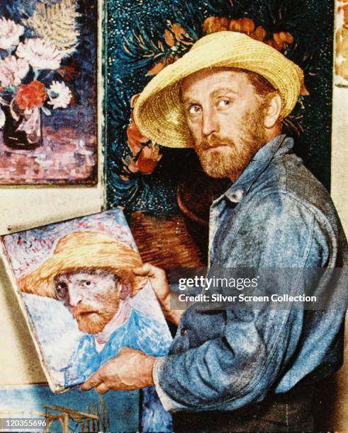Kirk Douglas, US actor, with a beard and straw hat, posing in front of a self-portrait, in a publicity still issued for the film, Lust for Life',...