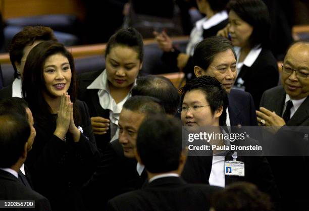 Yingluck Shinawatra reacts inside the chambers of the Parliament after the Thai parliament officially elected her as the country's first female Prime...