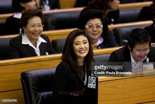Yingluck Shinawatra smiles inside the chambers after the Thai parliament officially elected her as the country's first female Prime Minister July 5,...