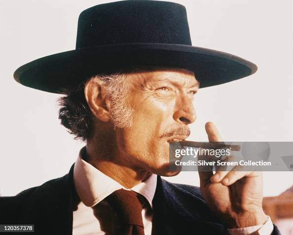 Headshot in profile of Lee Van Cleef , US actor, wearing a black