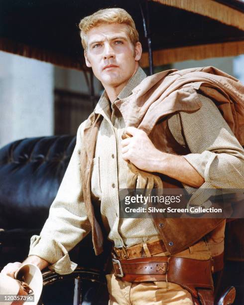 Lee Majors, US actor, wearing a tan leather wasitcoat with his jacket thrown over his shoulder in a publicity portrait for the US television series,...