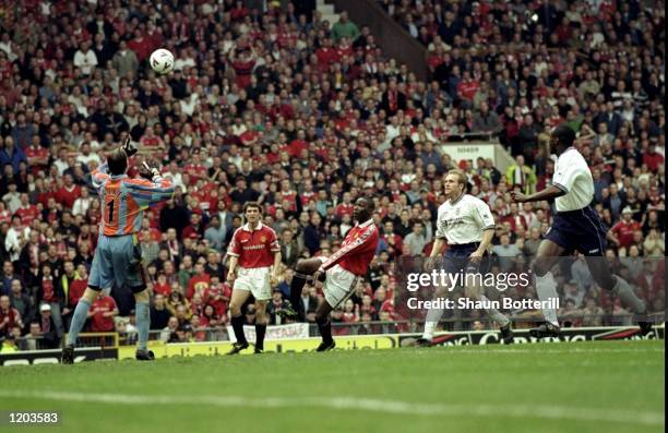 Andy Cole of Manchester United scores a superb winning goal over Ian Walker during the FA Carling Premiership match against Tottenham Hotspur played...