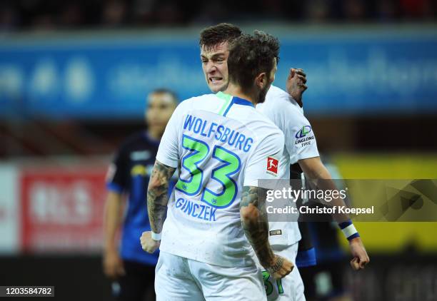 Robin Knoche of VfL Wolfsburg celebrates scoring his sides first goal with Daniel Ginczek of VfL Wolfsburg during the Bundesliga match between SC...