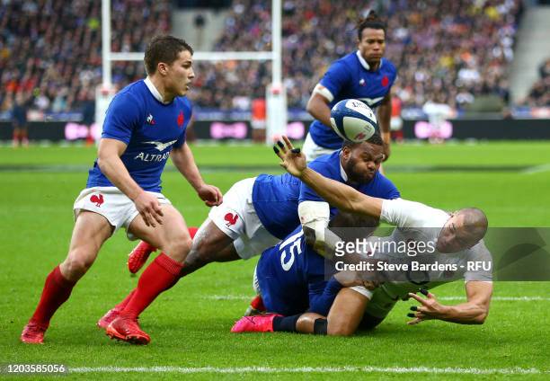 Jonathan Joseph of England is tackled by Anthony Bouthier and Virimi Vakatawa of France during the 2020 Guinness Six Nations match between France and...
