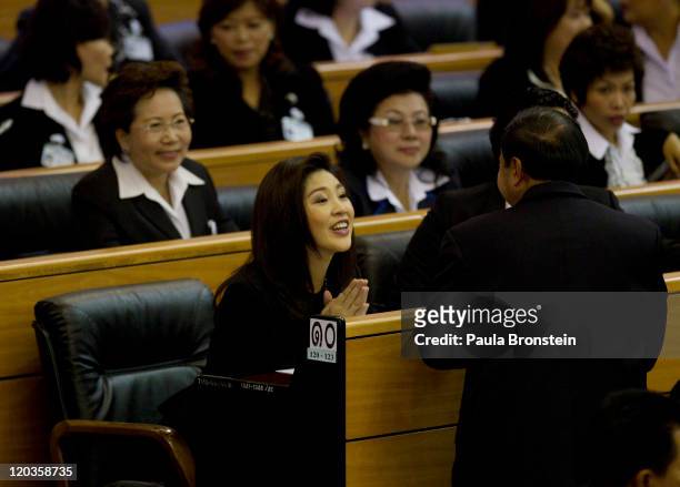 Yingluck Shinawatra reacts inside the chambers of the Parliament after the Thai parliament officially elected her as the country's first female Prime...