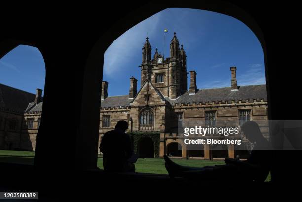 Students sit in the cloister of the quadrangle at the University of Sydney in Sydney, Australia, on Tuesday, Feb. 25, 2020. The coronavirus hit has...