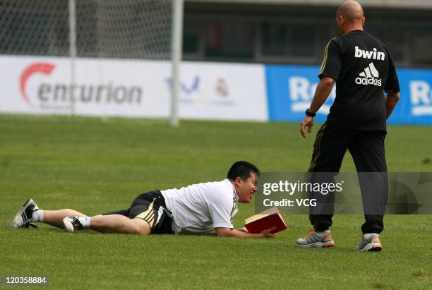 Fan of Real Madrid enters the field at a training session at Tianjin Water Drop Stadium on August 4, 2011 in Tianjin, China.