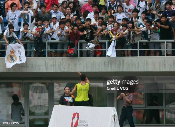 Cristiano Ronaldo of Real Madrid throws his jersey to the crowd at a training session at Tianjin Water Drop Stadium on August 4, 2011 in Tianjin,...