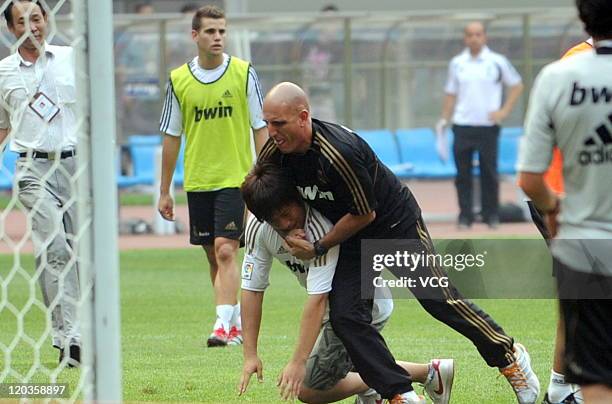 Fan of Real Madrid enters the field at a training session at Tianjin Water Drop Stadium on August 4, 2011 in Tianjin, China.