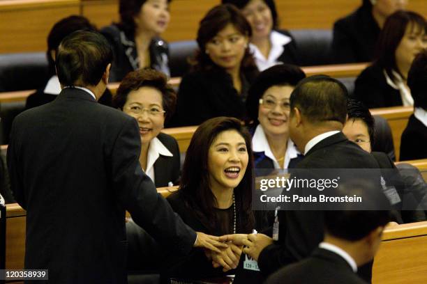 Yingluck Shinawatra talks to members of Parliament as the Thai parliament officially elected her as the country's first female Prime Minister July 5,...