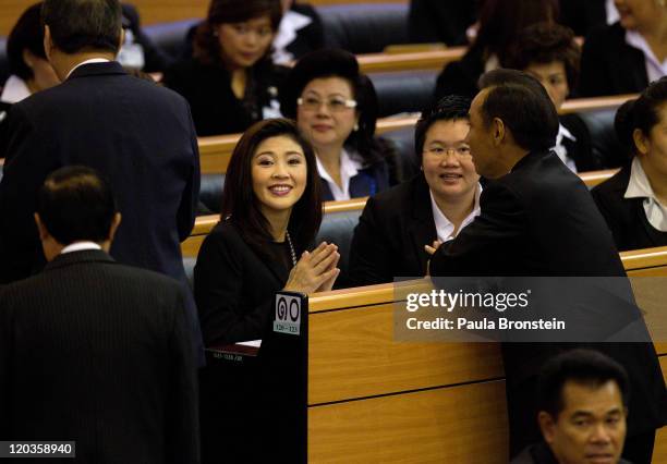 Yingluck Shinawatra talks to members of Parliament as the Thai parliament officially elected her as the country's first female Prime Minister July 5,...