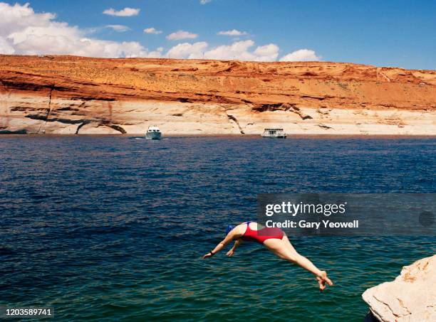 female swimmer diving in a lake - lake powell stock-fotos und bilder