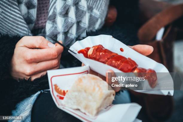 having curry sausage  in berlin - currywurst stock pictures, royalty-free photos & images
