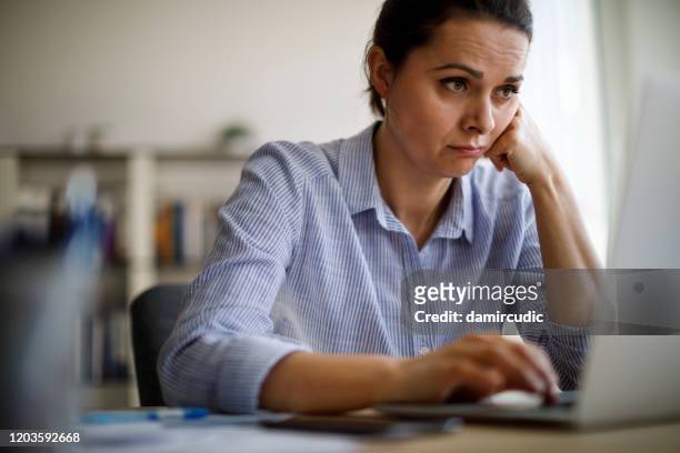 woman struggling with new technology - frustrated stock pictures, royalty-free photos & images
