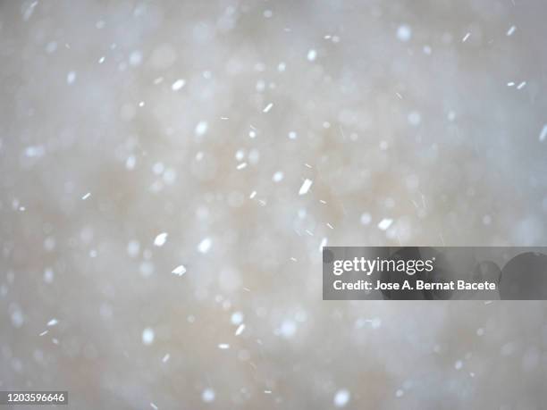 full frame snowstorm with the bottom of a stone wall. - 雪　降る ストックフォトと画像